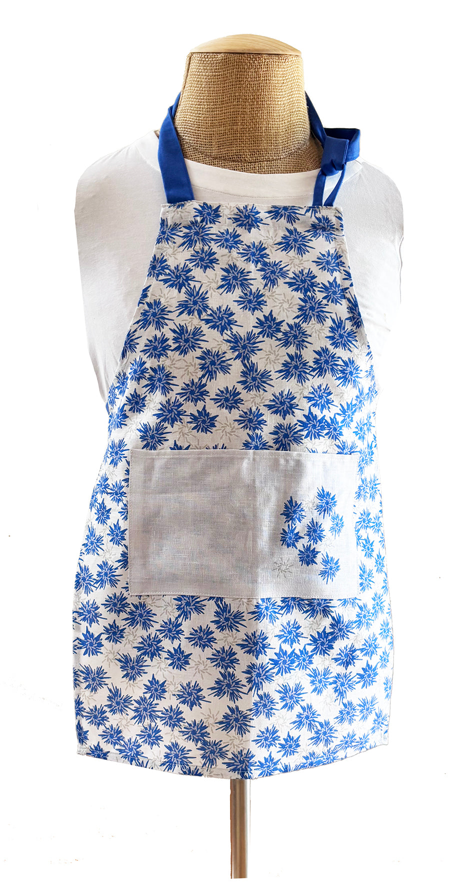 Rukki Fields of windswept cornflower 100% linen aprons.  Available in two sizes, adult and child.