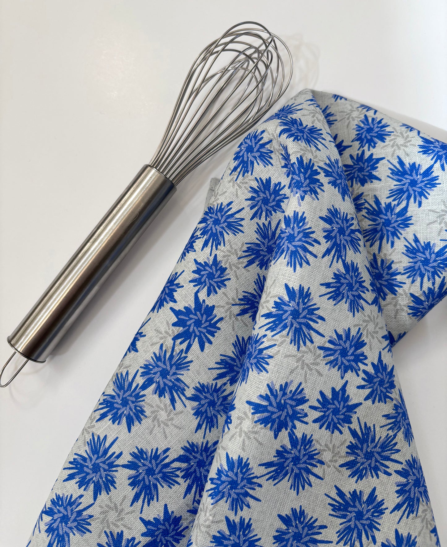 Rukki Fields of windswept cornflowers cover this 100% linen tea towel.